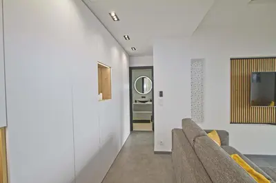 a living room with white walls and a couch at Luxury Garden Jacuzzi Promenade in Nice