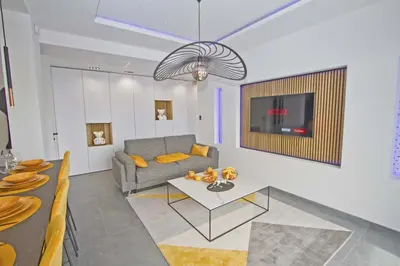 a living room with a couch and a table at Luxury Garden Jacuzzi Promenade in Nice