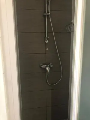 a shower in a bathroom with a hose at Charmant studio proche mer in Nice