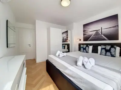 a white bedroom with two beds with white pillows at Nestor&Jeeves - FLOREAL BEACH - Central - Close sea in Nice