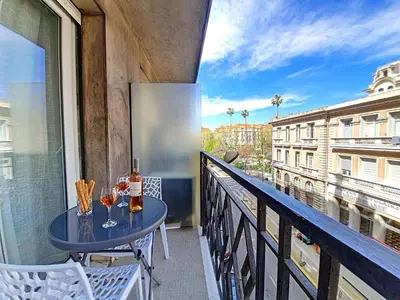a balcony with a table and two glasses of wine at Nestor&Jeeves - FLOREAL BEACH - Central - Close sea in Nice