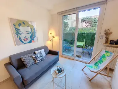 a living room with a blue couch and a window at Nestor&Jeeves - MARYLIN - Central - Very close sea in Nice