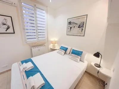 a white bedroom with a bed and a window at Nestor&Jeeves - MARYLIN - Central - Very close sea in Nice