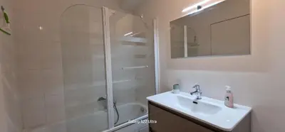 a bathroom with a shower and a sink and a mirror at HOME ET HOLIDAY Le Petit Manseng in Nice