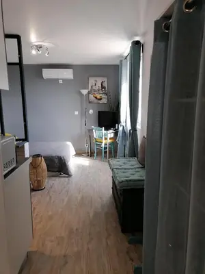 a living room with a couch and a table at Studio Anoe in Nice