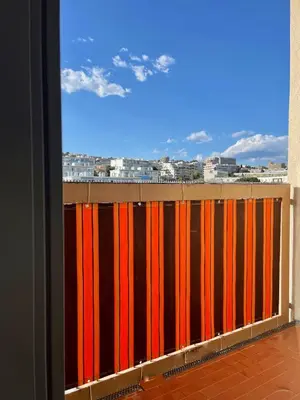 a red and orange fence with a view of a city at Nice Promenade 2 in Nice