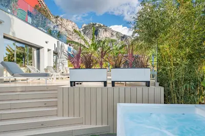 two chairs and a swimming pool in a house at GROUND FLOOR VILLA GRAZIELLA 200 M FROM THE BEACH in Èze
