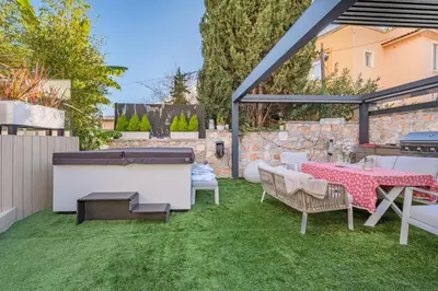 a patio with a table and chairs and a grill at GROUND FLOOR VILLA GRAZIELLA 200 M FROM THE BEACH in Èze