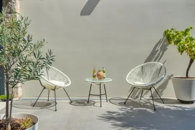 two chairs and a table with two drinks on it at GROUND FLOOR VILLA GRAZIELLA 200 M FROM THE BEACH in Èze