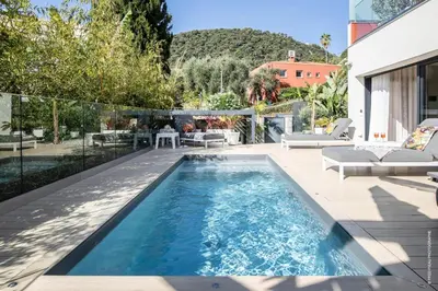 a swimming pool in the backyard of a house at GROUND FLOOR VILLA GRAZIELLA 200 M FROM THE BEACH in Èze