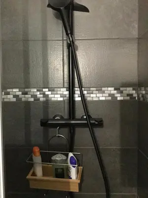 a bathroom with a shower with a black shower head at Studio Bel Air FSHH in Nice
