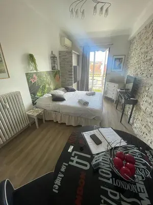 a bedroom with two beds and a table with fruit on it at Studio Bel Air FSHH in Nice