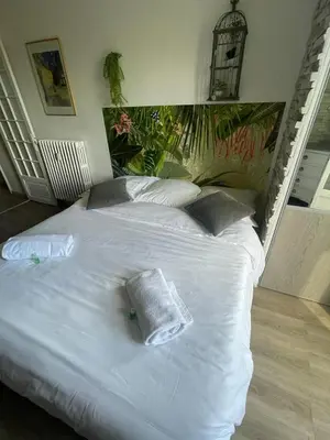 a white bed with two pillows on top of it at Studio Bel Air FSHH in Nice