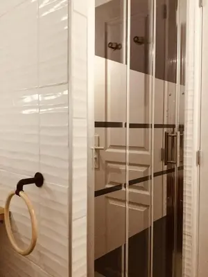 a shower with a glass door in a bathroom at Studio Bel Air FSHH in Nice