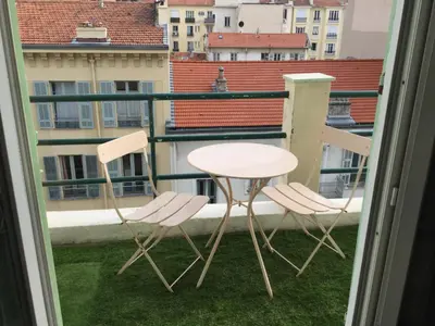 a table and chairs on a balcony with a view at Studio Bel Air FSHH in Nice
