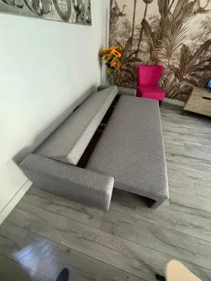 a bed in the corner of a room with pink chairs at Gorgeous 2 bedrooms holiday apartement in Nice