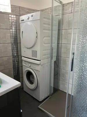 a washing machine in a bathroom with a shower at Gorgeous 2 bedrooms holiday apartement in Nice