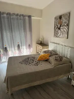 a bedroom with a bed and a painting on the wall at Gorgeous 2 bedrooms holiday apartement in Nice