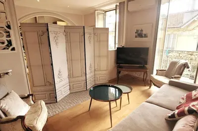 a living room with a couch and a table at From 1882, romantic flat, in the Golden Square in Nice