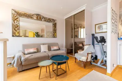 a living room with a couch and a table at From 1882, romantic flat, in the Golden Square in Nice