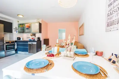 a kitchen with a table with blue plates on it at PALAIS LIBERTE V AP4267 By Riviera Holiday Homes in Nice
