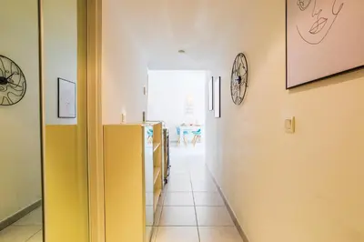 a hallway with a yellow door and a room at PALAIS LIBERTE V AP4267 By Riviera Holiday Homes in Nice