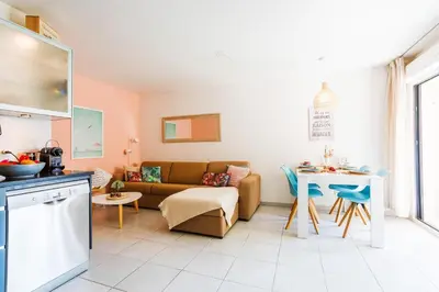 a living room with a couch and a table at PALAIS LIBERTE V AP4267 By Riviera Holiday Homes in Nice