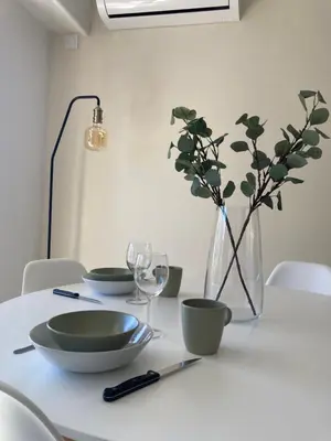 a table with four bowls and a vase on it at Habana in Saint-Laurent-du-Var