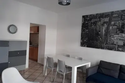 a living room with a table and chairs and a couch at Spacious Appartment Wifi Next To The Port in Nice