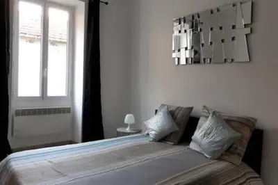 a bedroom with a large bed with a window at Spacious Appartment Wifi Next To The Port in Nice