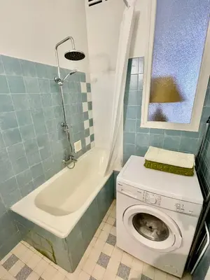 a bathroom with a toilet and a washing machine at Seaside vintage studio in Nice