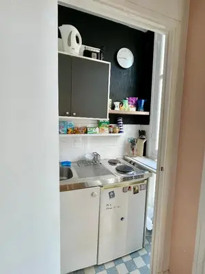 a small kitchen with a sink and a stove at Seaside vintage studio in Nice