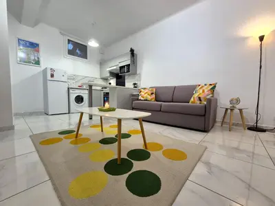 a living room with a couch and a table at Studio rénové au centre ville (15 min de la plage) in Nice