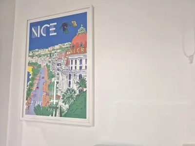 a picture on a wall with a painting on it at Studio rénové au centre ville (15 min de la plage) in Nice
