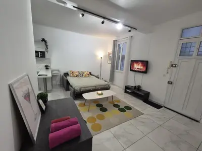 a living room with a couch and a table at Studio rénové au centre ville (15 min de la plage) in Nice