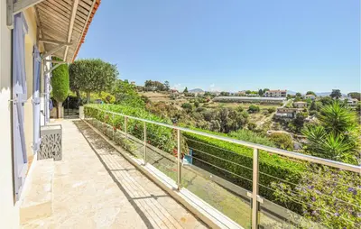 a balcony of a house with a view of a hill at Lovely Home In Saint-Laurent-Du-Var in Saint-Laurent-du-Var