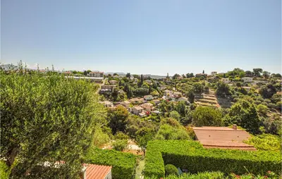 a view of a city from a hill with trees at Lovely Home In Saint-Laurent-Du-Var in Saint-Laurent-du-Var