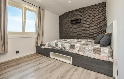 a bedroom with a large bed and a window at Lovely Home In Saint-Laurent-Du-Var in Saint-Laurent-du-Var