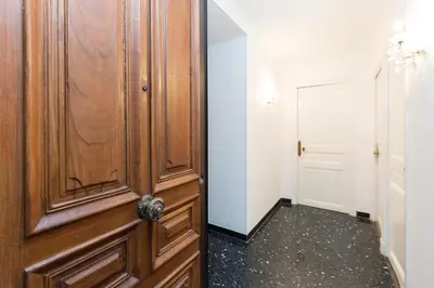 a wooden door in a room with a hallway at Appartement du Thiers in Nice