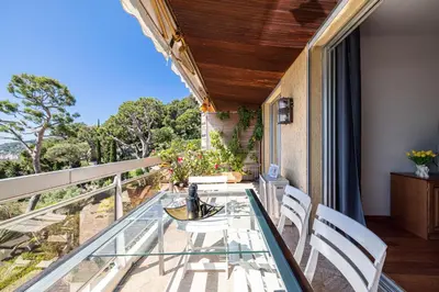 a glass table on the balcony of a house at Extraordinary Sea View - 1 Bdr with AC in Villefranche-sur-Mer