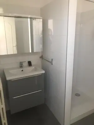 a white bathroom with a sink and a mirror at Villa Le Rêve in Nice