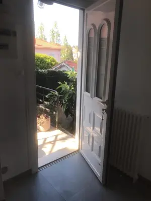 an open door with a view of a garden at Villa Le Rêve in Nice