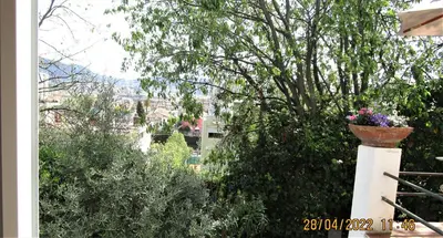 a garden with a flower pot on a pillar at NICE - STUDIO indépendant en VILLA - Mer ville calme jardinet in Nice