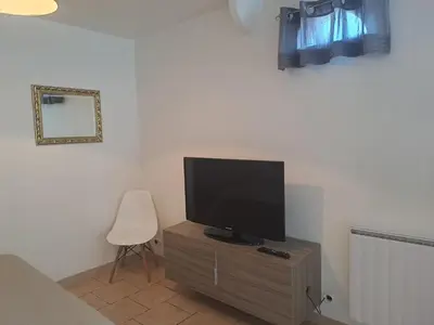 a television sitting on a wooden cabinet in a room at Loft 2 in La Trinité