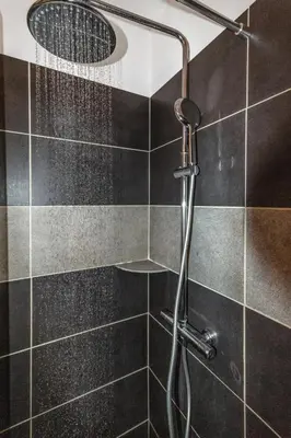 a shower with a shower head in a bathroom at Le Pied Dans L'eau - Parking - Seaside - Hipprodrome in Cagnes-sur-Mer