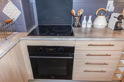 a kitchen with a stove and a counter top at Le Pied Dans L'eau - Parking - Seaside - Hipprodrome in Cagnes-sur-Mer