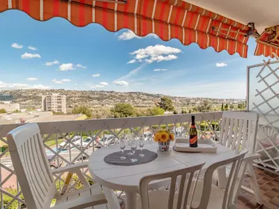 a table and chairs on a balcony with a view at Apartment Le Giono by Interhome in Saint-Laurent-du-Var