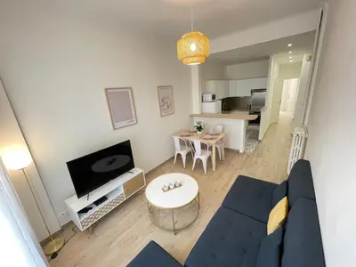 a living room with a blue couch and a table at Nice Renting - Penchienatti - Spacious Apartment - 2 BedRooms - King Bed - View Heart of Nice in Nice