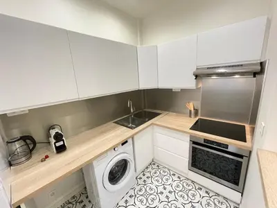 a kitchen with white cabinets and a washing machine at Nice Renting - Penchienatti - Spacious Apartment - 2 BedRooms - King Bed - View Heart of Nice in Nice