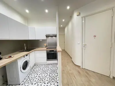 a kitchen with white cabinets and a washer and dryer at Nice Renting - Penchienatti - Spacious Apartment - 2 BedRooms - King Bed - View Heart of Nice in Nice